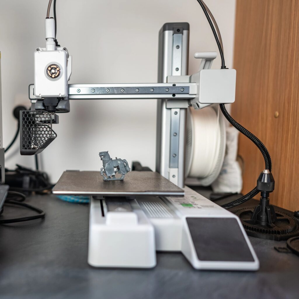 Modular 3D-printed desk cable organizer holding charging cables on a tidy desk