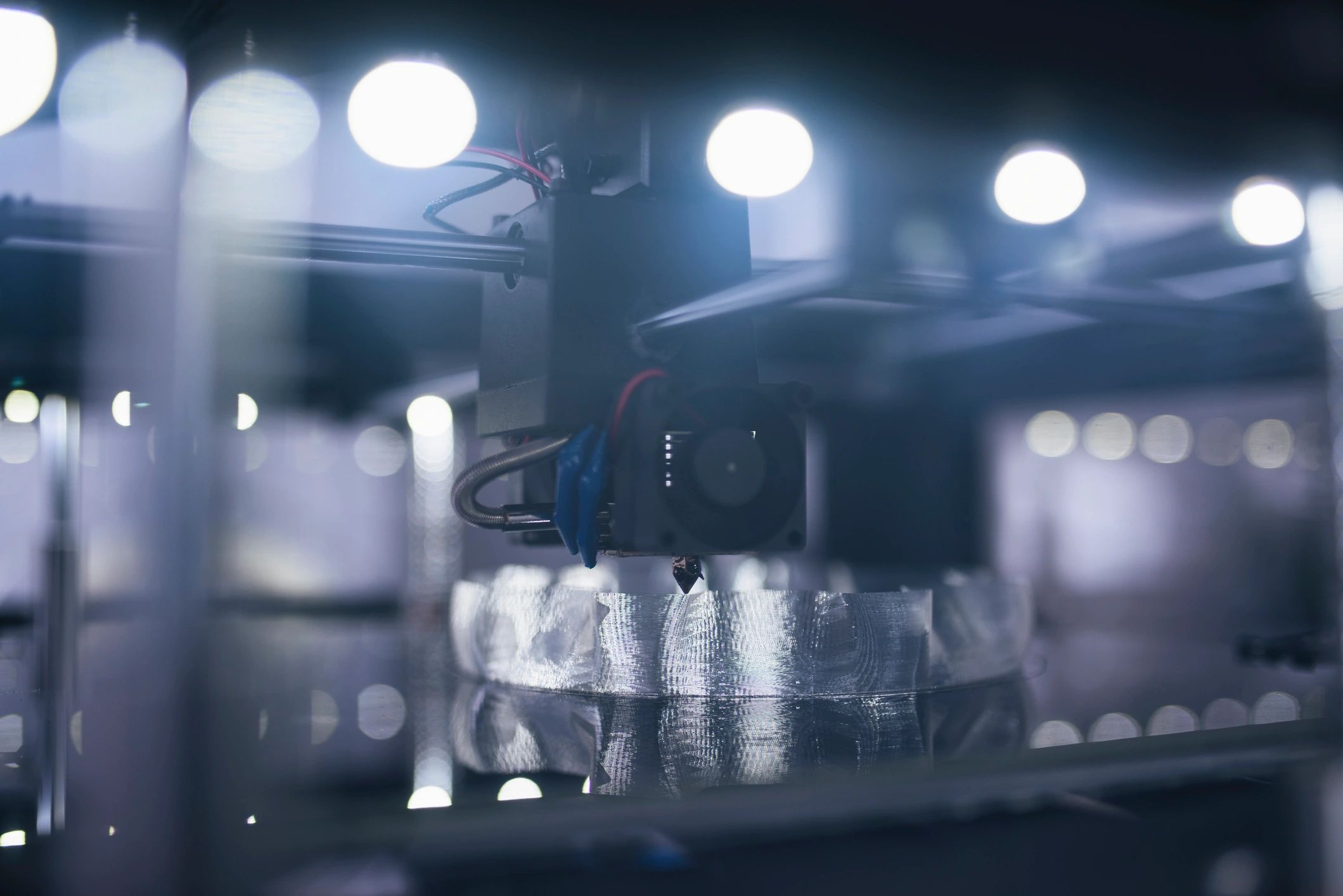 Close-up of a 3D printer printing a small object